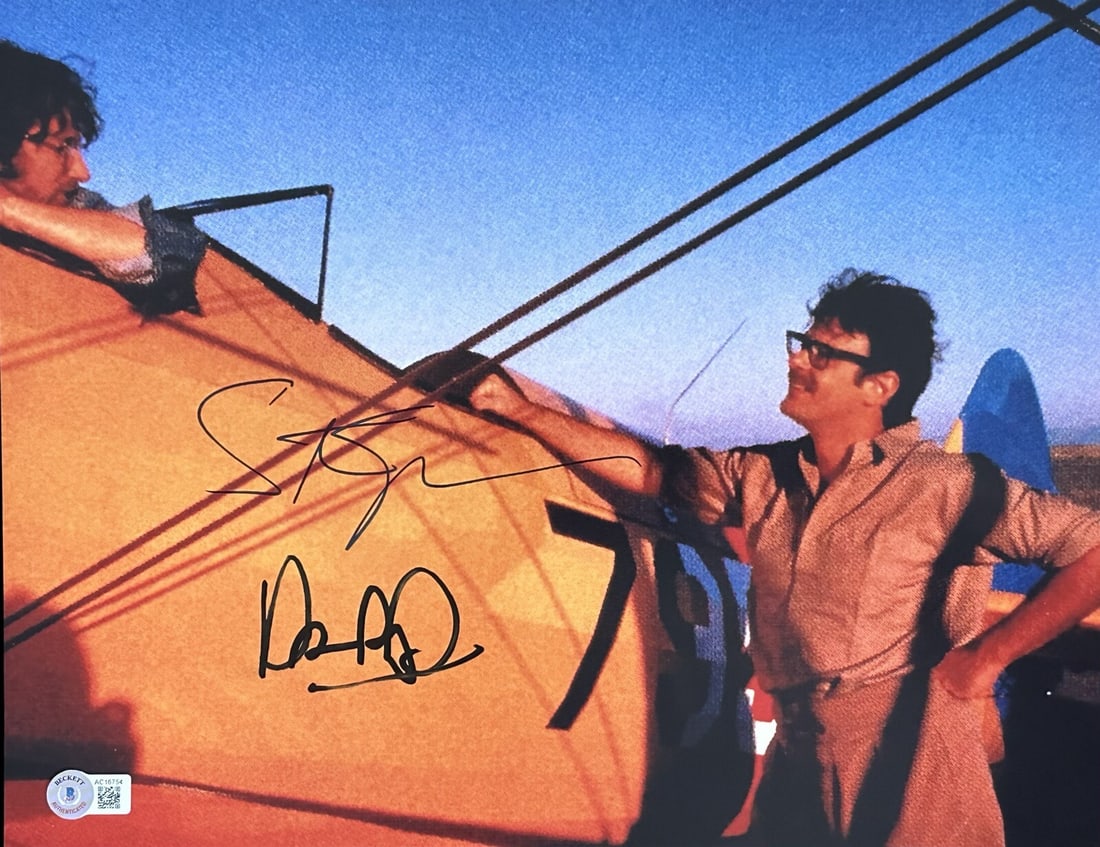 Indiana Jones Temple of Doom 11x14 Photo Signed by Spielberg and Aykroyd Beckett LOA: Indiana Jones Temple of Doom 11x14 Photo Signed by Spielberg and Aykroyd Beckett LOA This is an autographed 11x14 color photograph signed by Steven Spielberg and Dan Aykroyd. The photo features a behi