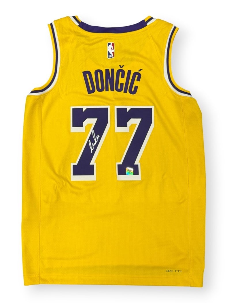 Signed Los Angeles Lakers Yellow Icon Swingman Jersey by Luka Doncic: Signed Los Angeles Lakers Yellow Icon Swingman Jersey by Luka Doncic This is a pre-owned, original yellow Swingman Jersey, Icon Edition, autographed by Luka Doncic. The jersey features the Los Angeles