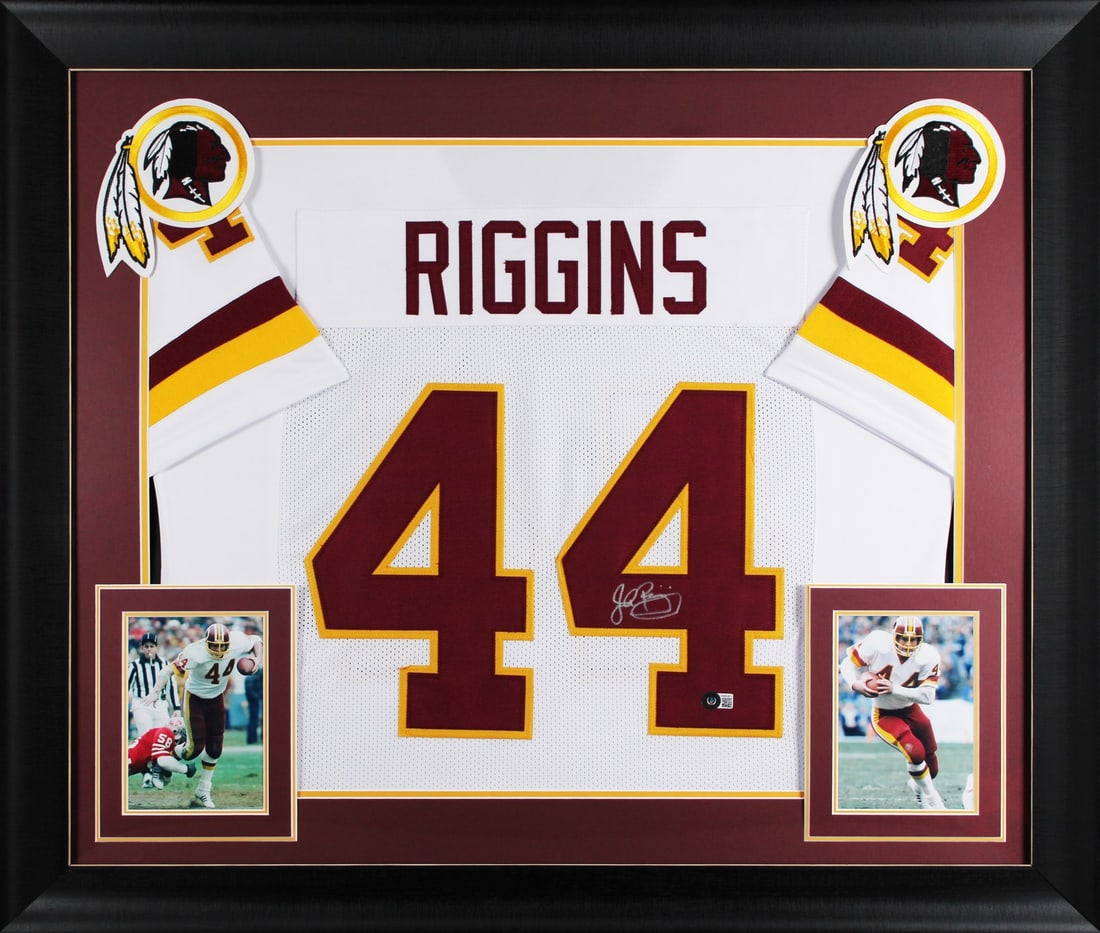 Framed White Jersey Signed by John Riggins Beckett Witnessed Authentication: Framed White Jersey Signed by John Riggins Beckett Witnessed Authentication This professionally framed white pro style jersey is personally signed by John Riggins of the Washington Commanders. The aut