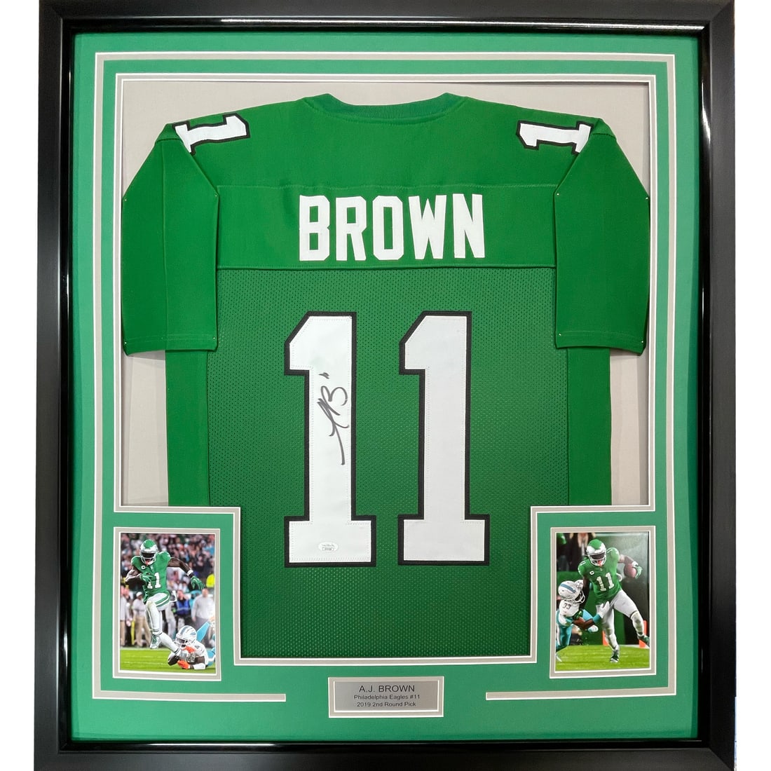 Framed AJ Brown Autographed Jersey Philadelphia Eagles JSA COA 33x42: Framed AJ Brown Autographed Jersey Philadelphia Eagles JSA COA 33x42 This professionally framed and matted display features an autographed Kelly Green jersey of AJ Brown, a prominent player for the Ph