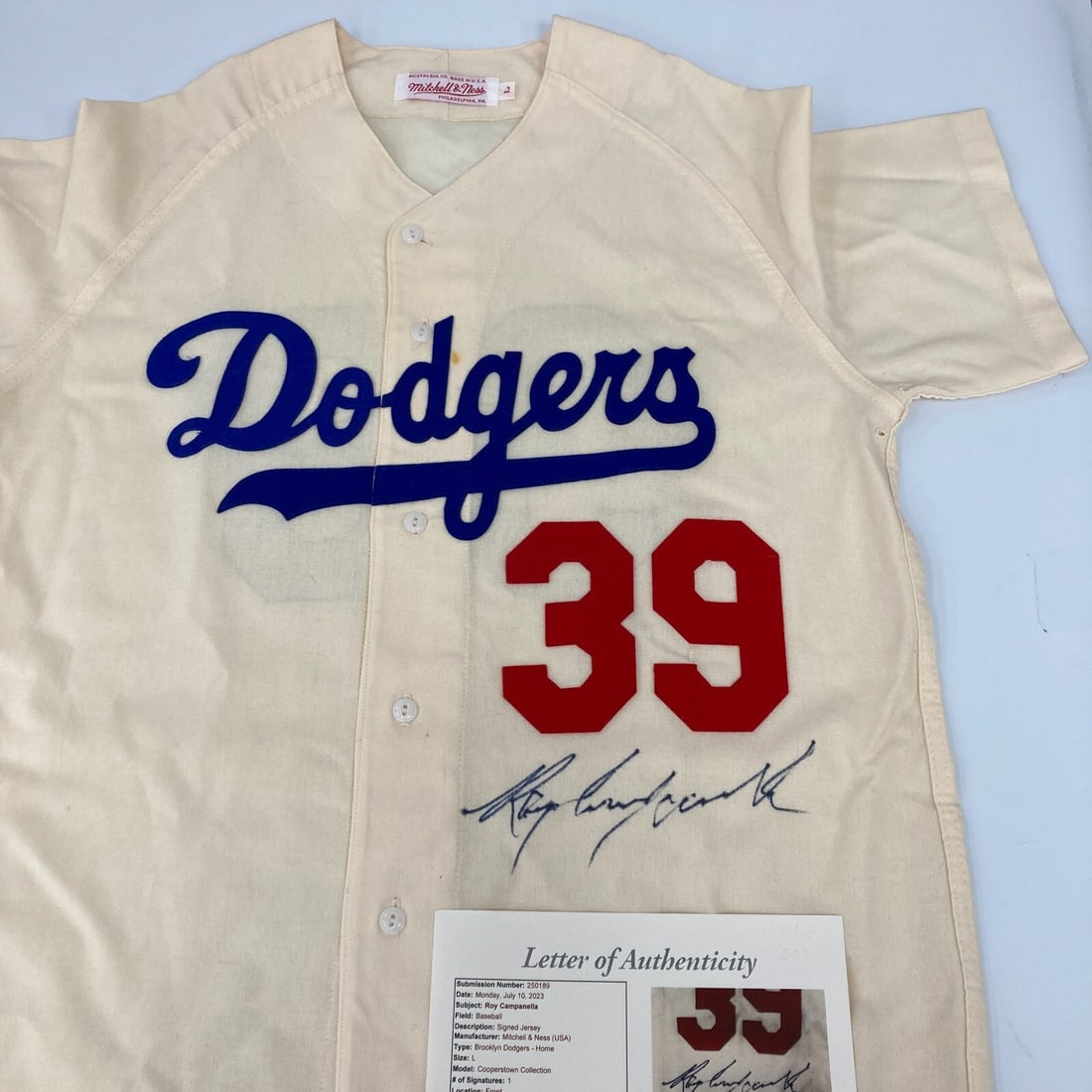Roy Campanella Signed Brooklyn Dodgers Jersey with JSA COA: Roy Campanella Signed Brooklyn Dodgers Jersey with JSA COA This authentic game model jersey is a rare find, signed by the legendary Roy Campanella, a celebrated player of the Brooklyn Dodgers. The jer