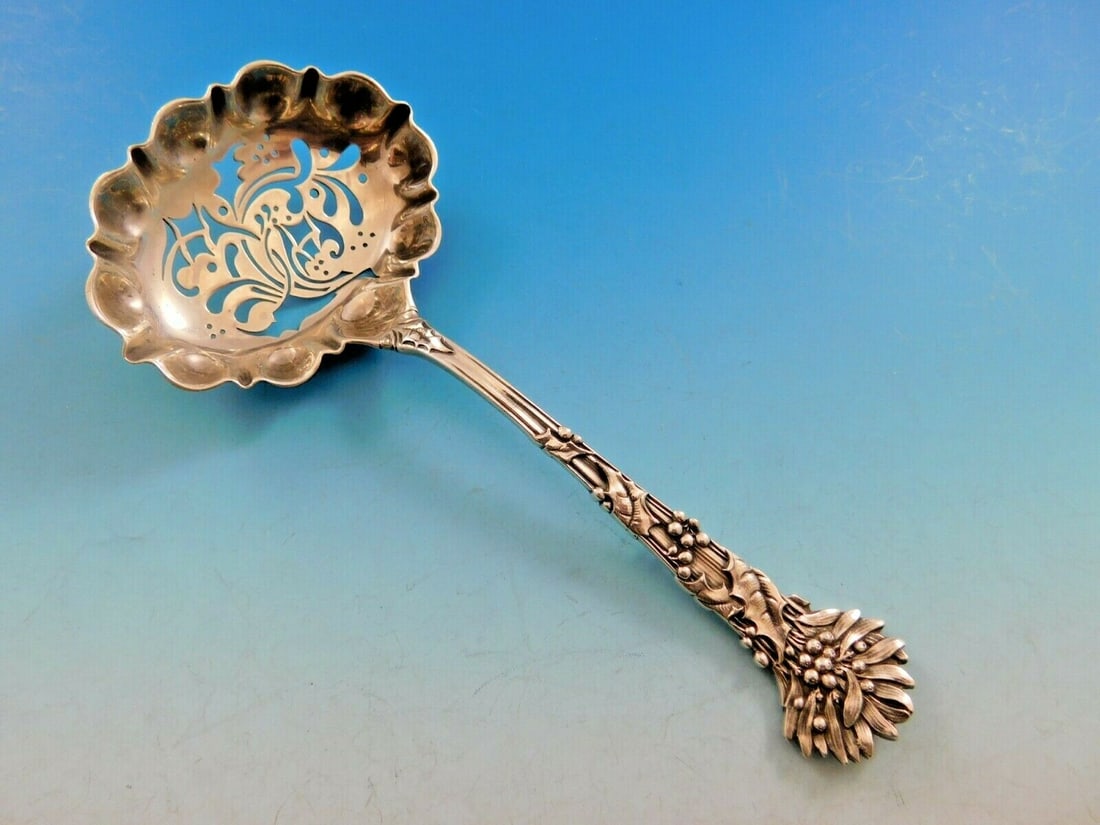 Tiffany & Co. Holly Pattern Sterling Silver Sugar Sifter 5 7/8": Tiffany & Co. Holly Pattern Sterling Silver Sugar Sifter 5 7/8" This stunning sugar sifter from the Holly pattern by Tiffany & Co. showcases exquisite craftsmanship in sterling silver. Measuring 5 7/8