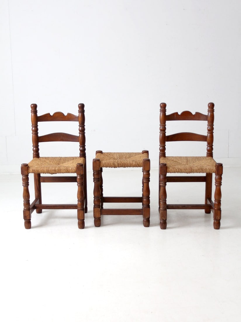 Rustic French Country Rush Seat Chair and Stool Set: Rustic French Country Rush Seat Chair and Stool Set This exquisite early 20th century rush seat chair and stool set showcases the rustic charm of French Country style. The set includes two side chairs