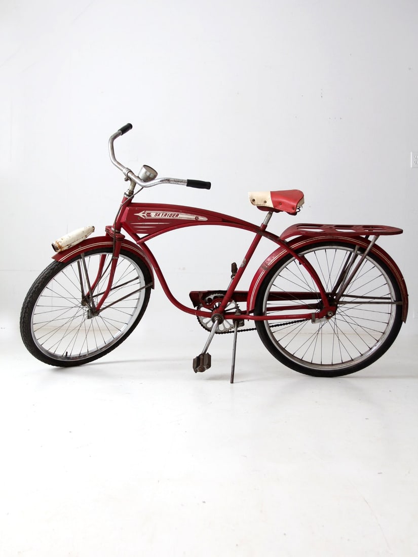 Vintage 1960s AMF Skyrider Bicycle Red White Decorative Piece: Vintage 1960s AMF Skyrider Bicycle Red White Decorative Piece This vintage AMF Skyrider bicycle from the early 1960s features a striking classic red and white design, enhanced by a Cadet speedometer a