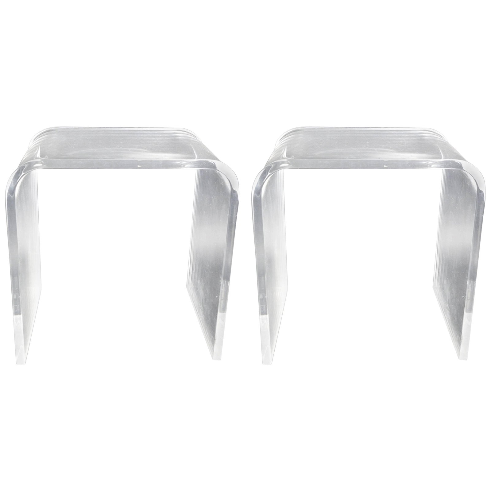 Vintage Lucite Waterfall Side Tables Pair 1970s-1980s: Vintage Lucite Waterfall Side Tables Pair 1970s-1980s This elegant pair of Lucite waterfall side tables features a heavy cast construction, ensuring durability and stability. Crafted with thick Lucite