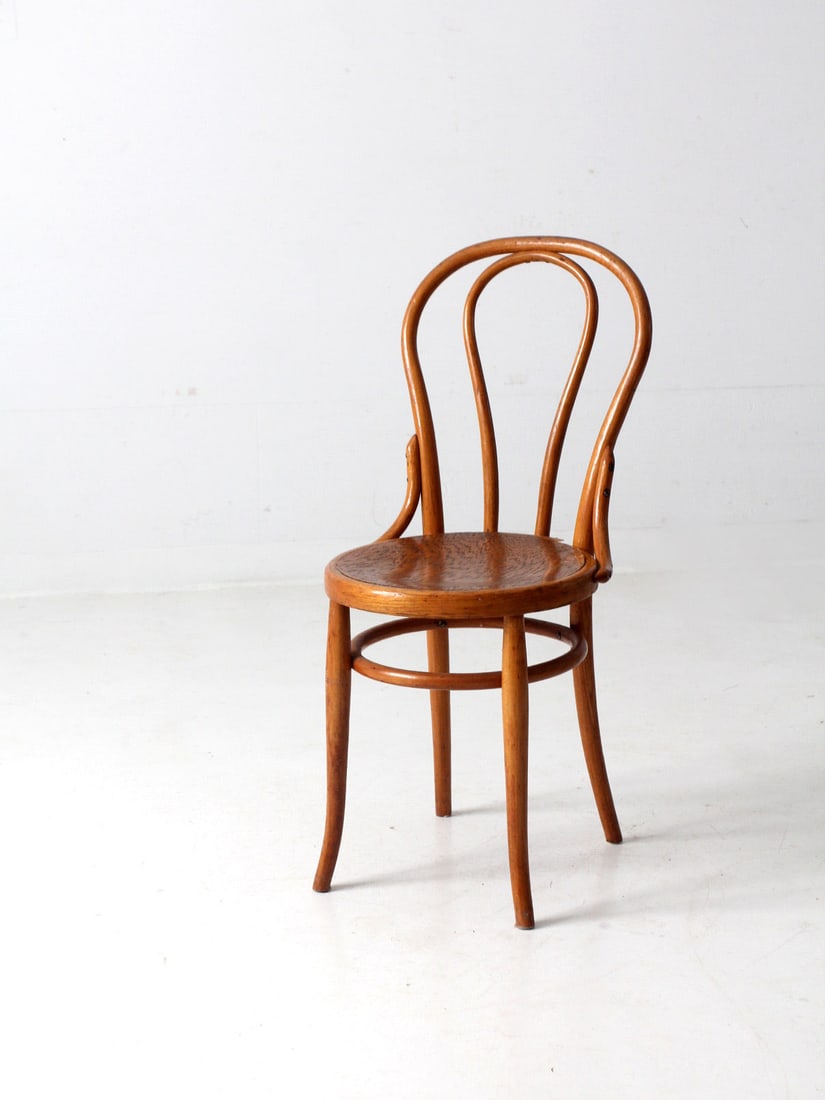Vintage Thonet Style Antique Bentwood Cafe Chair Honey Tone: Vintage Thonet Style Antique Bentwood Cafe Chair Honey Tone This exquisite Antique Bentwood Cafe Chair, inspired by the classic Thonet design, dates back to the early 20th century. It features a timel