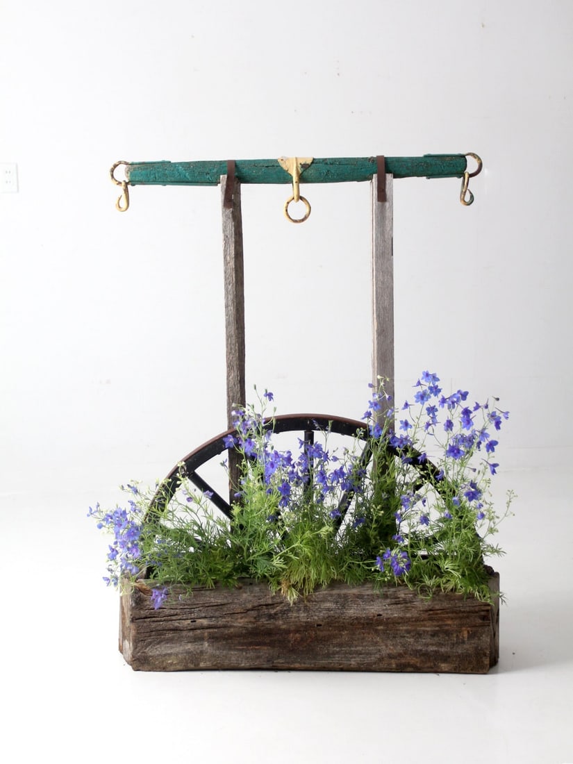 Rustic Vintage Folk Art Wagon Wheel Planter with Antique Horse Yoke: Rustic Vintage Folk Art Wagon Wheel Planter with Antique Horse Yoke Introducing a unique vintage folk art planter that adds charm to any outdoor space. This handmade piece features a rustic wood plant