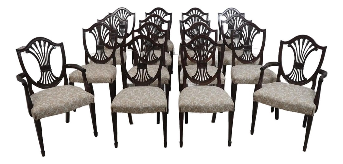 16 Mahogany Shield Back Dining Chairs with Carved Wheat Sheaf Design Set of 16: 16 Mahogany Shield Back Dining Chairs with Carved Wheat Sheaf Design Set of 16 This set includes 16 Stickley dining chairs crafted from mahogany, featuring finely carved shield backs with wheat sheaf 