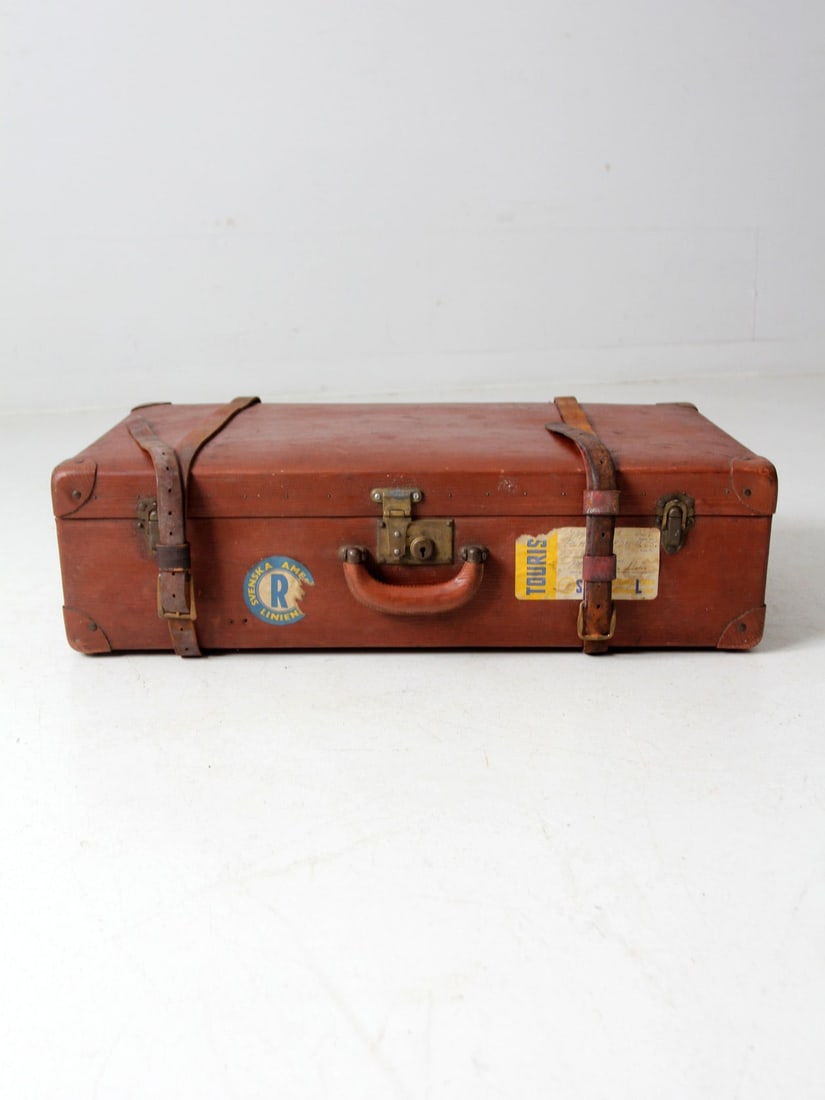 Vintage Utica Vulkanfibre Luggage with Swedish American Line Stickers: Vintage Utica Vulkanfibre Luggage with Swedish American Line Stickers This vintage Utica Vulkanfibre steamer ship luggage from the 1940s-1960s showcases a rich brown exterior adorned with original lea