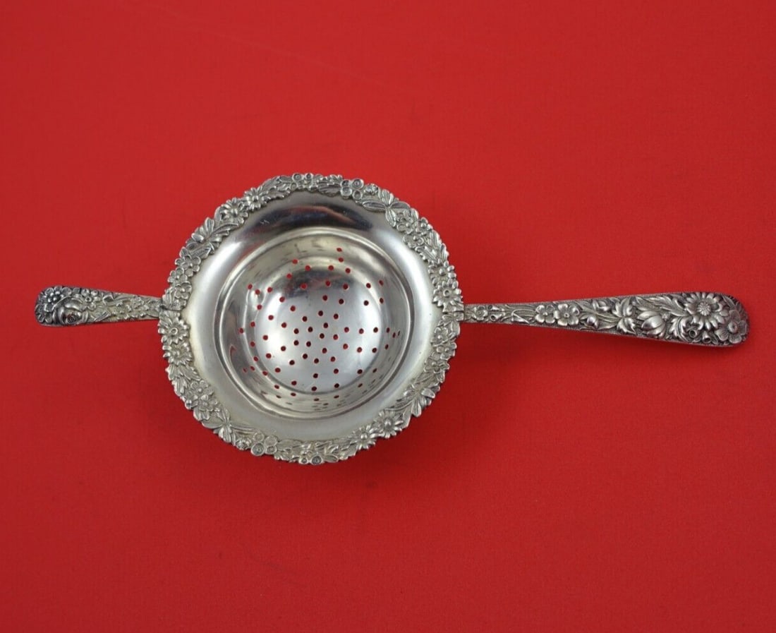 Kirk Repousse Sterling Silver Tea Strainer Double Handle 7 3/4": Kirk Repousse Sterling Silver Tea Strainer Double Handle 7 3/4" This exquisite tea strainer showcases the timeless Repousse pattern by Kirk, crafted from high-quality sterling silver (.925). Featuring