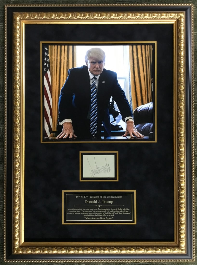 Donald Trump Autographed Large Framed Display with PSA DNA Authentication: Donald Trump Autographed Large Framed Display with PSA DNA Authentication This custom-framed display features an authentic autograph of President Donald J. Trump. The signature has been fully authenti
