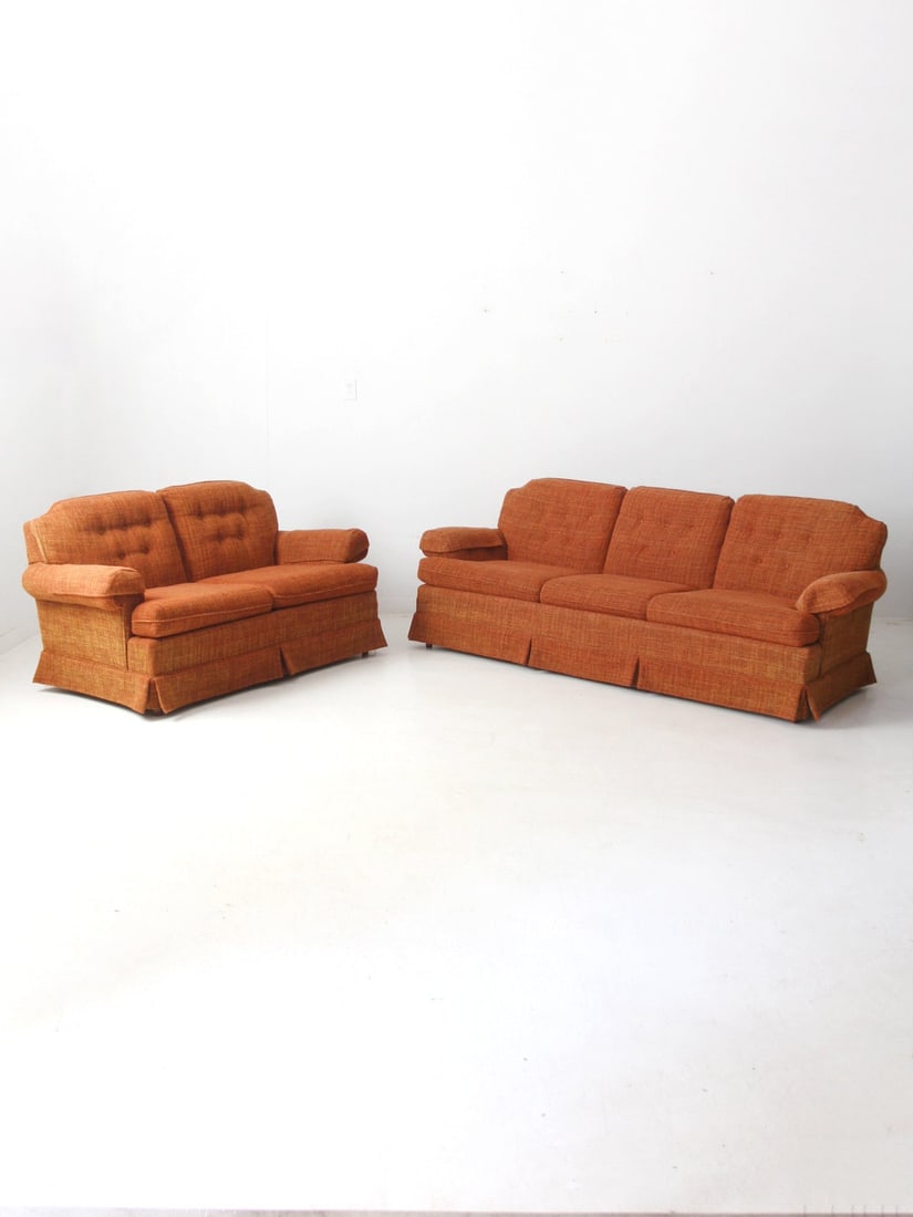 Mid-Century Vintage Orange Tweed Sofa Loveseat Set: Mid-Century Vintage Orange Tweed Sofa Loveseat Set This vintage sofa set features a three-seat couch and a matching loveseat, both crafted from a warm orange tweed fabric. The textured weave, tailored