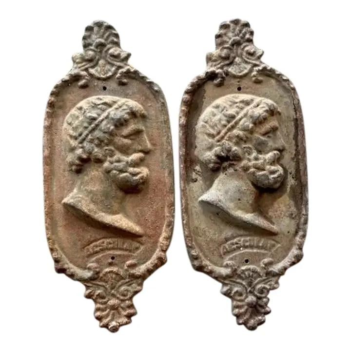 Vintage Cast Iron Asclepius Plaque Pair Neoclassical Wall Art: Vintage Cast Iron Asclepius Plaque Pair Neoclassical Wall Art Add a touch of classical elegance to your space with this stunning pair of vintage cast iron wall plaques featuring the profile of Asclepi