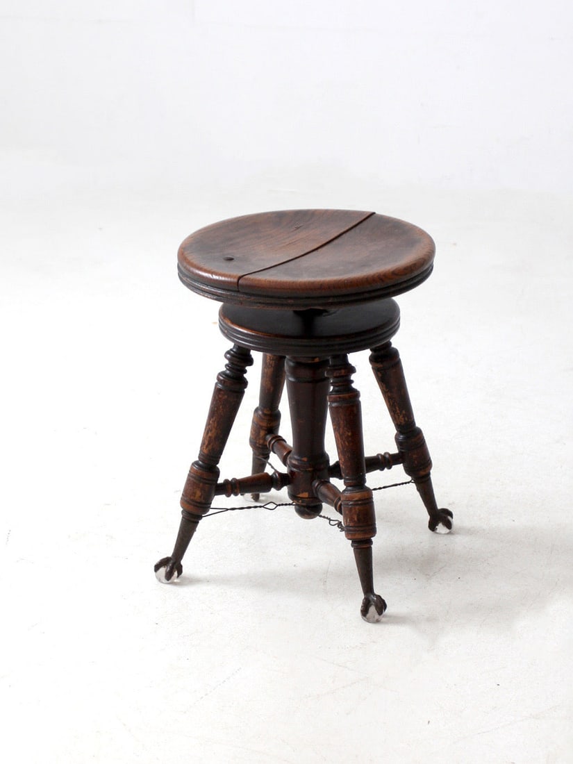 Vintage Late 1800s Claw and Ball Foot Piano Stool: Vintage Late 1800s Claw and Ball Foot Piano Stool This antique piano stool, dating back to the late 1800s, showcases a unique cast iron swivel mechanism and elegantly turned wood legs reinforced with 