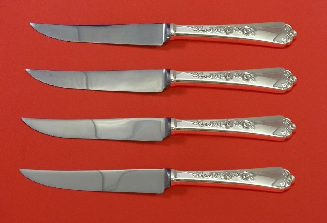 Wallace Sterling Rose 4pc Steak Knife Set Custom 8.5": Wallace Sterling Rose 4pc Steak Knife Set Custom 8.5" Enhance your dining experience with this exquisite 4-piece steak knife set in the Sterling Rose pattern by Wallace. Each knife features a hollow h