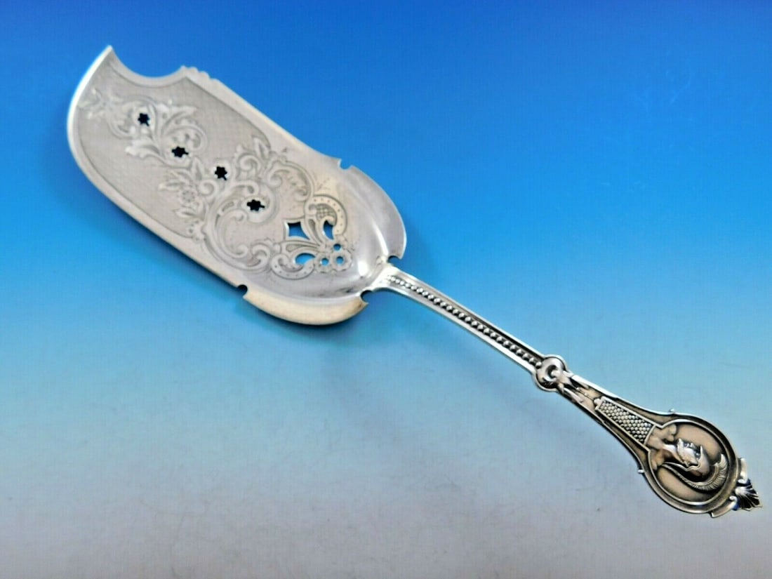 Wood & Hughes Medallion Warrior Sterling Silver Fish Server 10": Wood & Hughes Medallion Warrior Sterling Silver Fish Server 10" This exceptional fish server, crafted by Wood & Hughes, showcases the elegant Medallion pattern, also known as Warrior. Measuring 10 inc