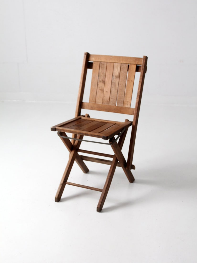 1940s Vintage Wooden Folding Auditorium Chair for Storage: 1940s Vintage Wooden Folding Auditorium Chair for Storage This vintage wooden folding chair, dating back to the 1940s, offers a unique charm to any room with its warm patinated wood finish. Designed f