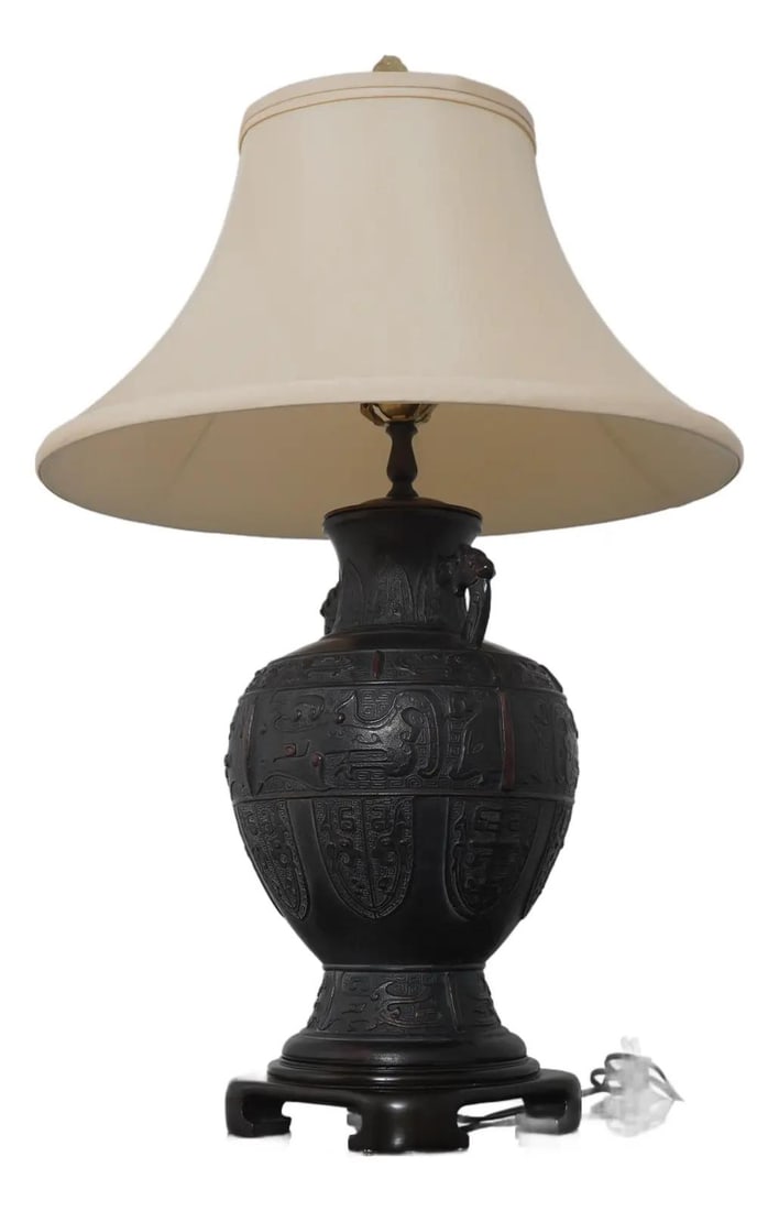 Bronze Urn Table Lamp with Chinese Motif by Wildwood Circa 1990s: Bronze Urn Table Lamp with Chinese Motif by Wildwood Circa 1990s This table lamp features a heavy bronze urn design inspired by Chinese artistry, crafted with quality construction. The lamp remains in