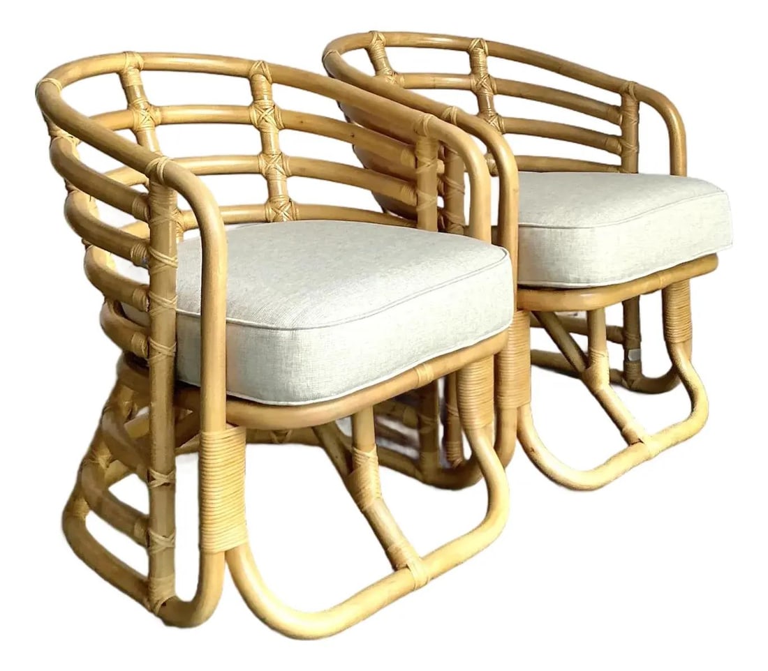 Pair of Bohemian Vintage Bent Rattan Barrel Lounge Chairs with Cushions: Pair of Bohemian Vintage Bent Rattan Barrel Lounge Chairs with Cushions This pair of vintage bent rattan lounge chairs features sculptural, barrel-back frames crafted from natural rattan with detailed