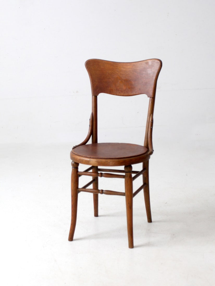 Vintage Bentwood Side Chair with Curved Backrest: Vintage Bentwood Side Chair with Curved Backrest This antique bentwood side chair features a gracefully curved backrest and rounded seat, supported by turned stretchers and slender legs. Its elegant p