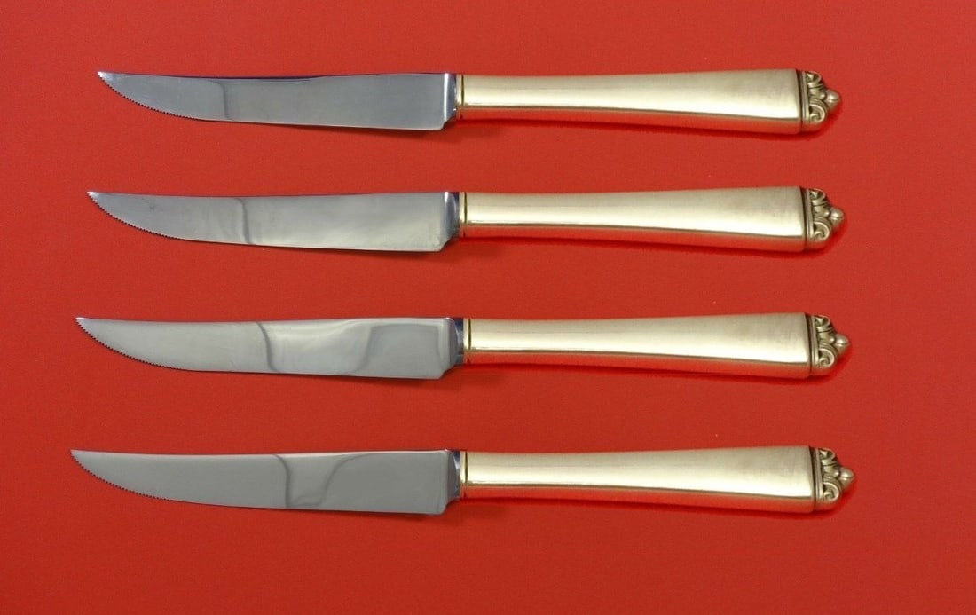 Oneida Reigning Beauty 4pc Sterling Silver Steak Knife Set: Oneida Reigning Beauty 4pc Sterling Silver Steak Knife Set Elevate your dining experience with this exquisite 4-piece steak knife set in the stunning Reigning Beauty pattern by Oneida. Crafted from hi
