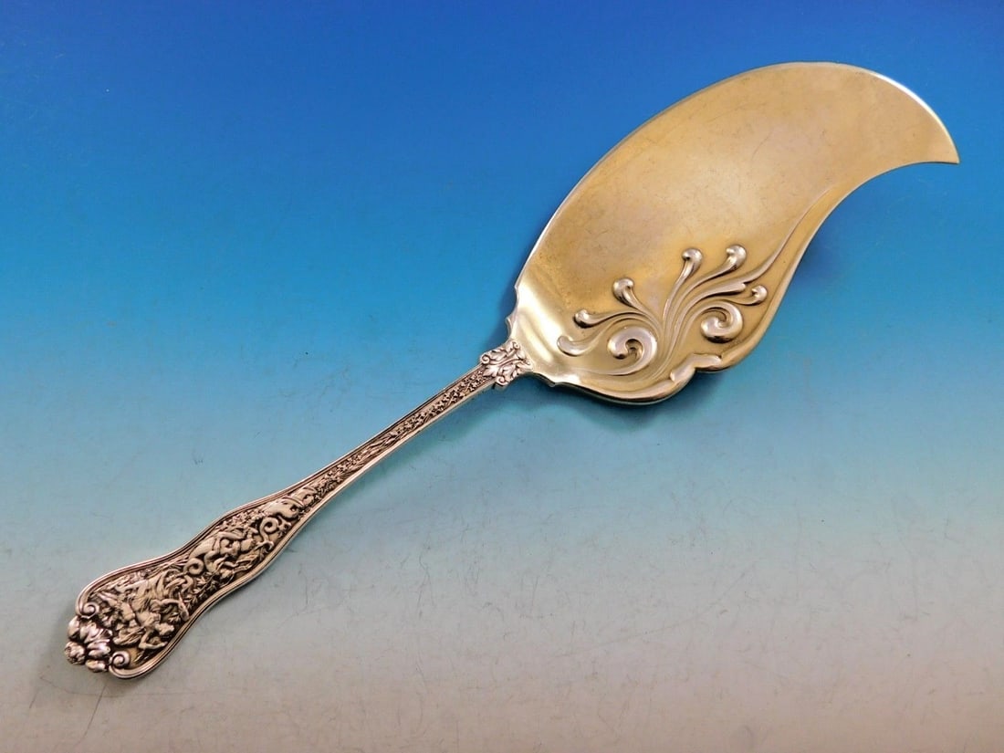 Tiffany & Co Olympian Sterling Silver Ice Cream Slice Venus Design 11 1/4": Tiffany & Co Olympian Sterling Silver Ice Cream Slice Venus Design 11 1/4" Experience the elegance of the Olympian pattern with this exquisite ice cream slice from Tiffany & Co. Crafted from sterling 