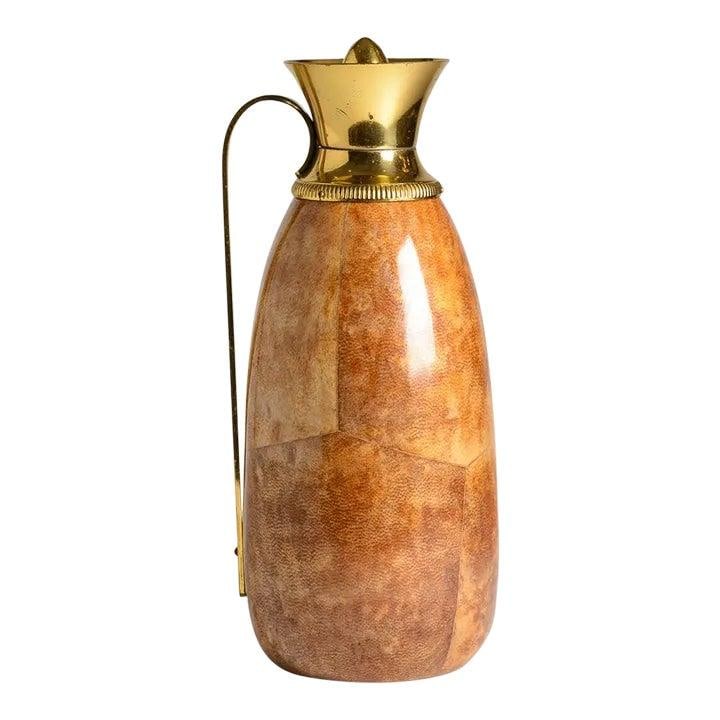 1960s Aldo Tura Lacquered Goatskin Brass Thermos Vintage: 1960s Aldo Tura Lacquered Goatskin Brass Thermos Vintage This exquisite Italian thermos, designed by Aldo Tura in the 1960s, features a stunning lacquered goatskin exterior in a beautiful honey color.