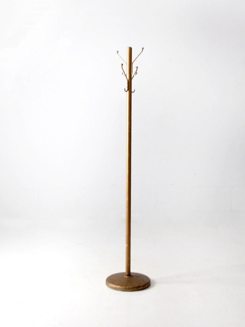 Mid-Century Gold Tone Aluminum Hall Coat Rack with 4 Hooks: Mid-Century Gold Tone Aluminum Hall Coat Rack with 4 Hooks This mid-century vintage coat rack showcases a stylish brass-tone aluminum finish. Designed for practicality, it features a weighted round ba