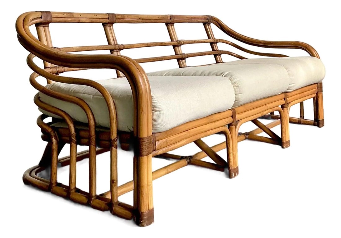 Mid Century Rattan Three Seat Sofa in Style of Calcutta Collection: Mid Century Rattan Three Seat Sofa in Style of Calcutta Collection This vintage bent rattan sofa, attributed to the design quality of Brown Jordan and inspired by the "Calcutta" collection, features r