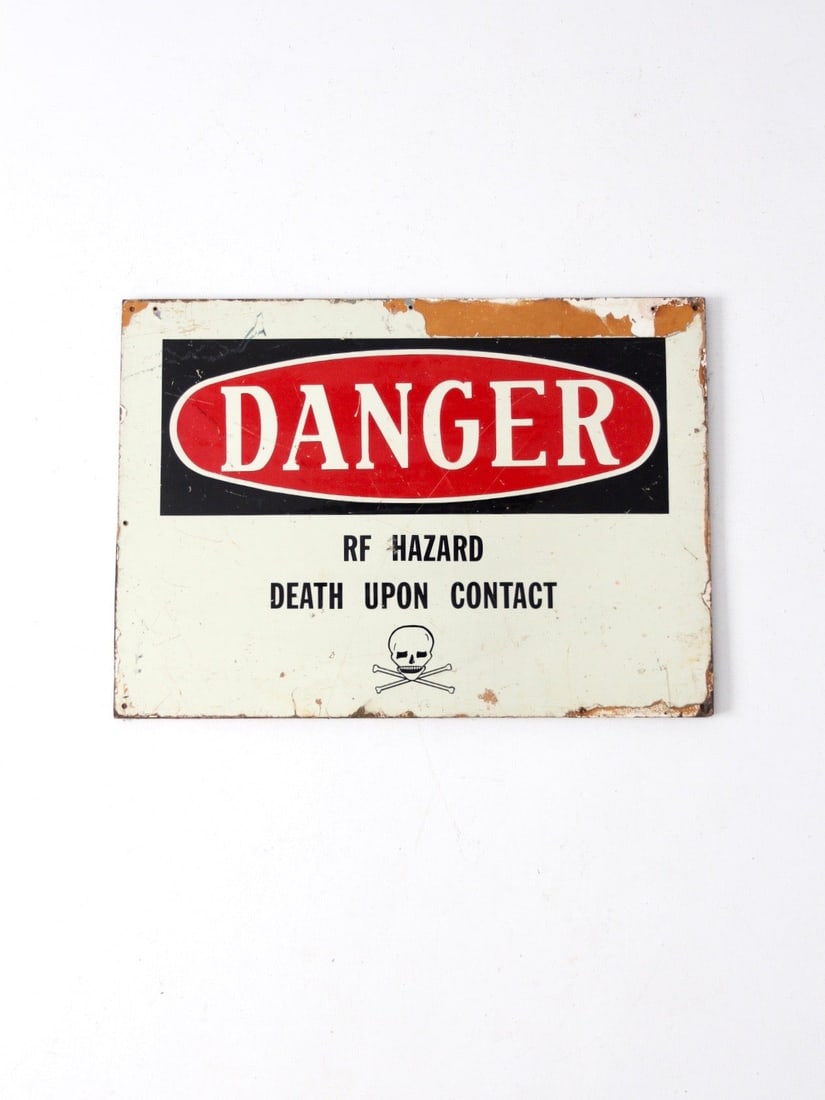Mid 20th Century Vintage Metal Danger Sign RF Hazard Skull: Mid 20th Century Vintage Metal Danger Sign RF Hazard Skull This vintage metal "Danger" sign is a striking piece from the early mid 20th century, featuring a prominent "DANGER" emblem alongside a skull
