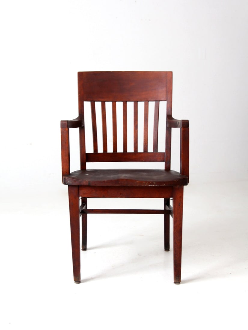 Early 20th Century Arts & Crafts Wooden Library Chair: Early 20th Century Arts & Crafts Wooden Library Chair This exquisite early 20th century wooden armchair embodies the classic Arts & Crafts style. It features a traditional slat back and a comfortably 