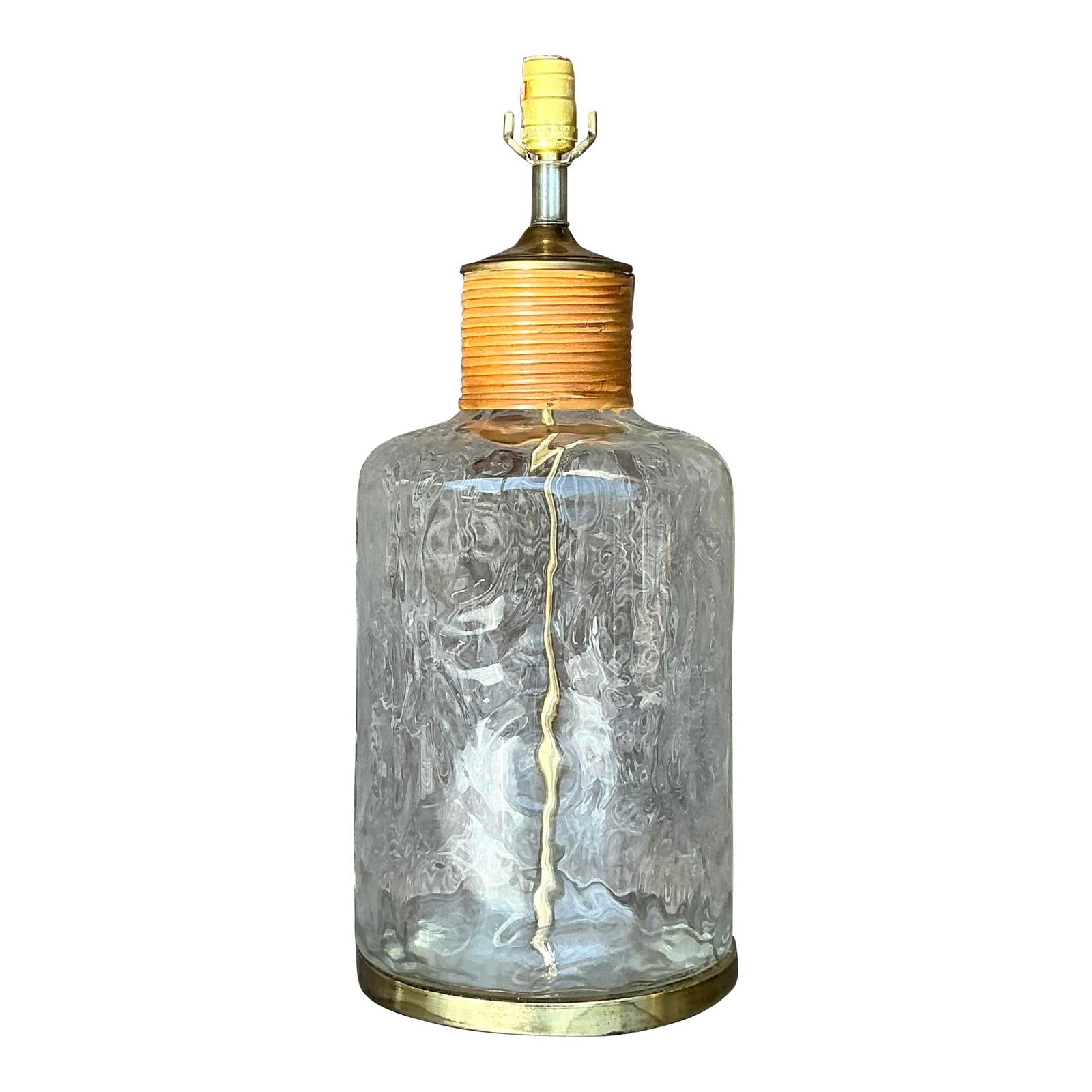 Vintage Rattan Glass Lamp with Brass Accent 22 in Tall: Vintage Rattan Glass Lamp with Brass Accent 22 in Tall This vintage glass jug lamp showcases a stunning clear glass base adorned with subtle textural patterns that beautifully reflect light. Accented 