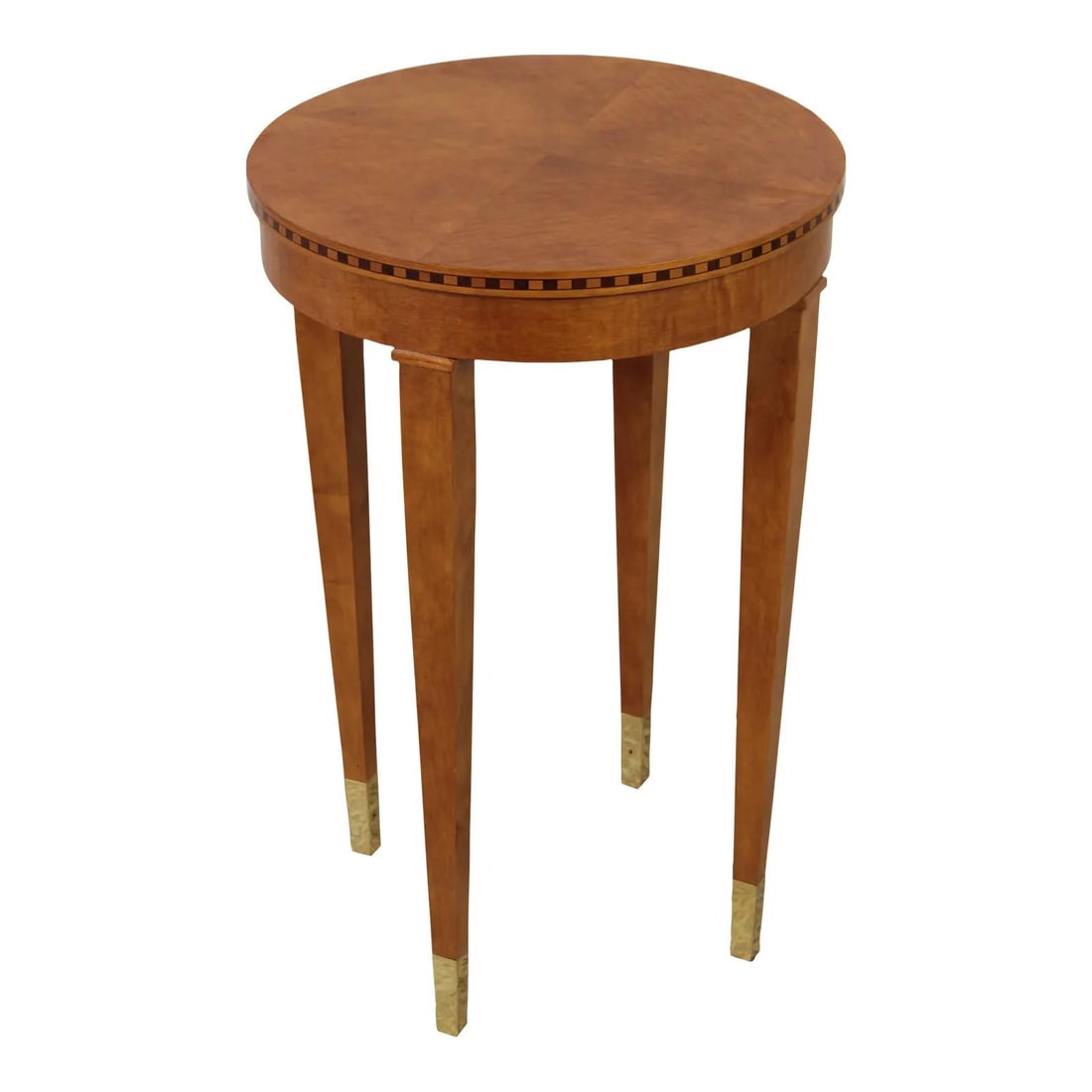Round Maple End Table with Brass Capped Feet and Inlay Genesis Collection: Round Maple End Table with Brass Capped Feet and Inlay Genesis Collection This round maple end table features a neoclassical design with elegant checkered inlay on the edge and tapered legs. Part of t