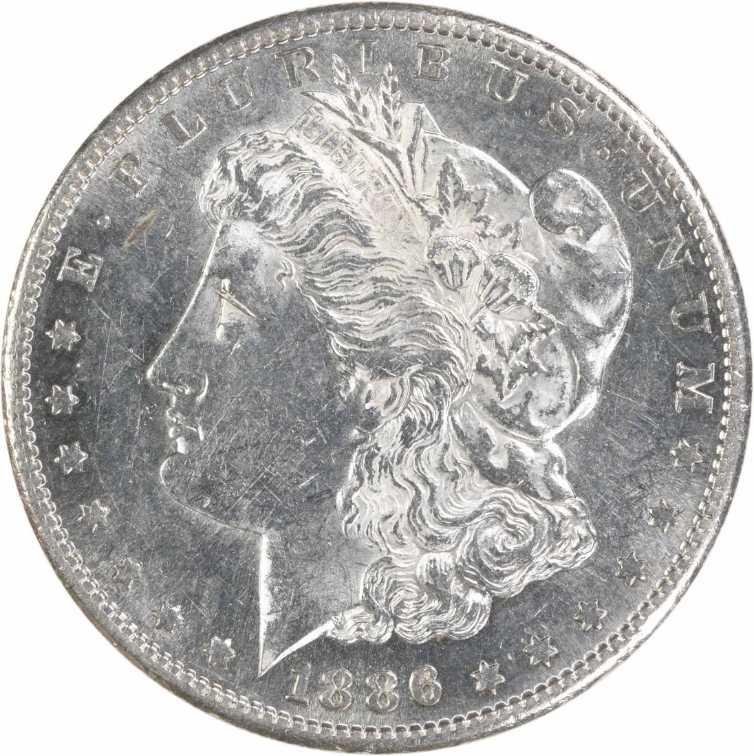 1886-S Morgan Silver Dollar AU Uncertified 90% Silver Coin: 1886-S Morgan Silver Dollar AU Uncertified 90% Silver Coin This 1886-S Morgan Silver Dollar is a stunning piece of numismatic history, showcasing the artistry of designer George T. Morgan. The coin fe