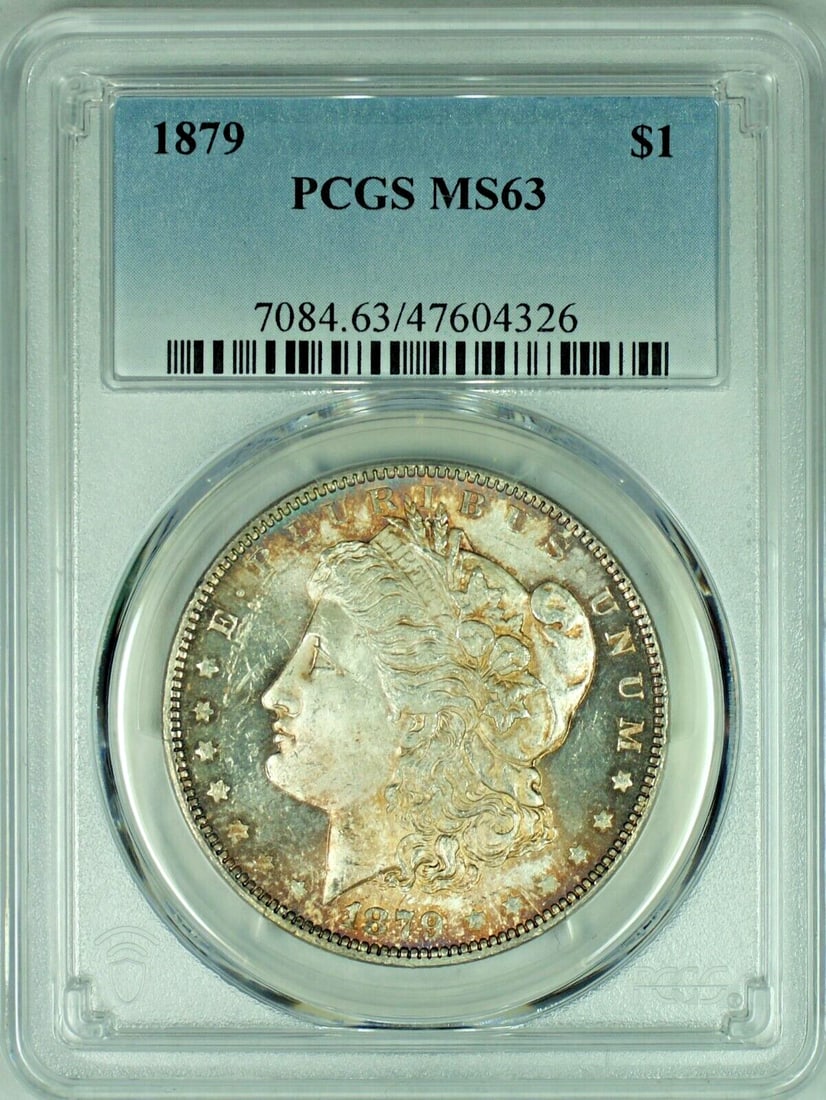 PCGS MS 63 1879 Silver Morgan Dollar with Toning: PCGS MS 63 1879 Silver Morgan Dollar with Toning This is an 1879 Morgan Silver Dollar from the United States, featuring a toned appearance. The coin is uncirculated and has been graded MS 63 by PCGS, 