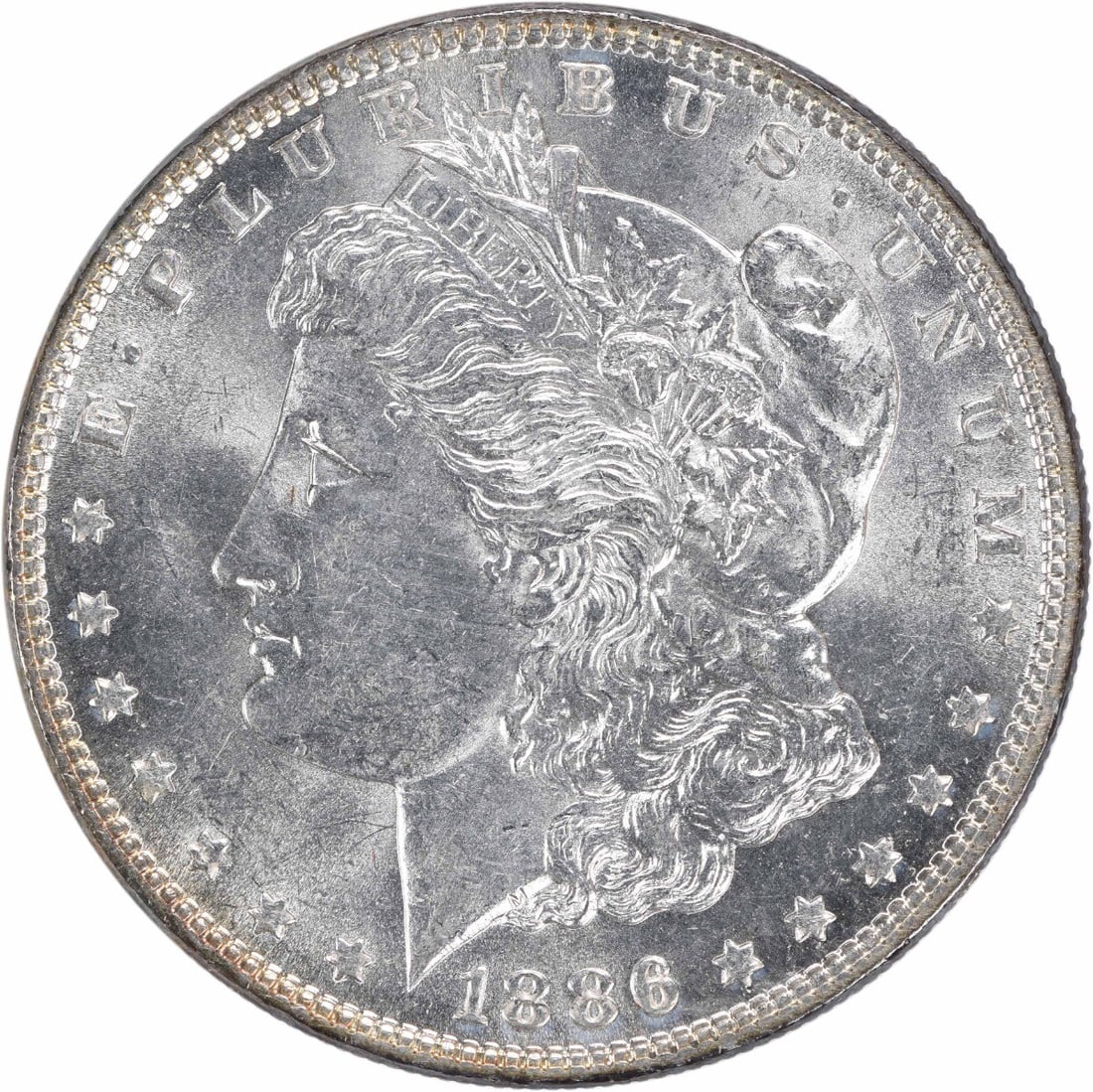 Toned 1886 Morgan Dollar Silver Coin Choice BU Uncertified: Toned 1886 Morgan Dollar Silver Coin Choice BU Uncertified This 1886 Morgan Silver Dollar is a Choice Brilliant Uncirculated (BU) coin, featuring attractive toning. It is uncertified and does not have