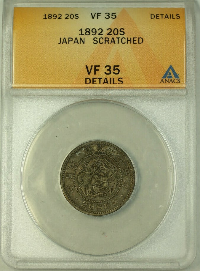 Japan 1892 Silver 20 Sen ANACS VF 35 Y24 With Scratch Notation: Japan 1892 Silver 20 Sen ANACS VF 35 Y24 With Scratch Notation This is a 1892 Japan 20 Sen coin composed of silver. It has been certified by ANACS with a grade of VF 35 and features scratched details.