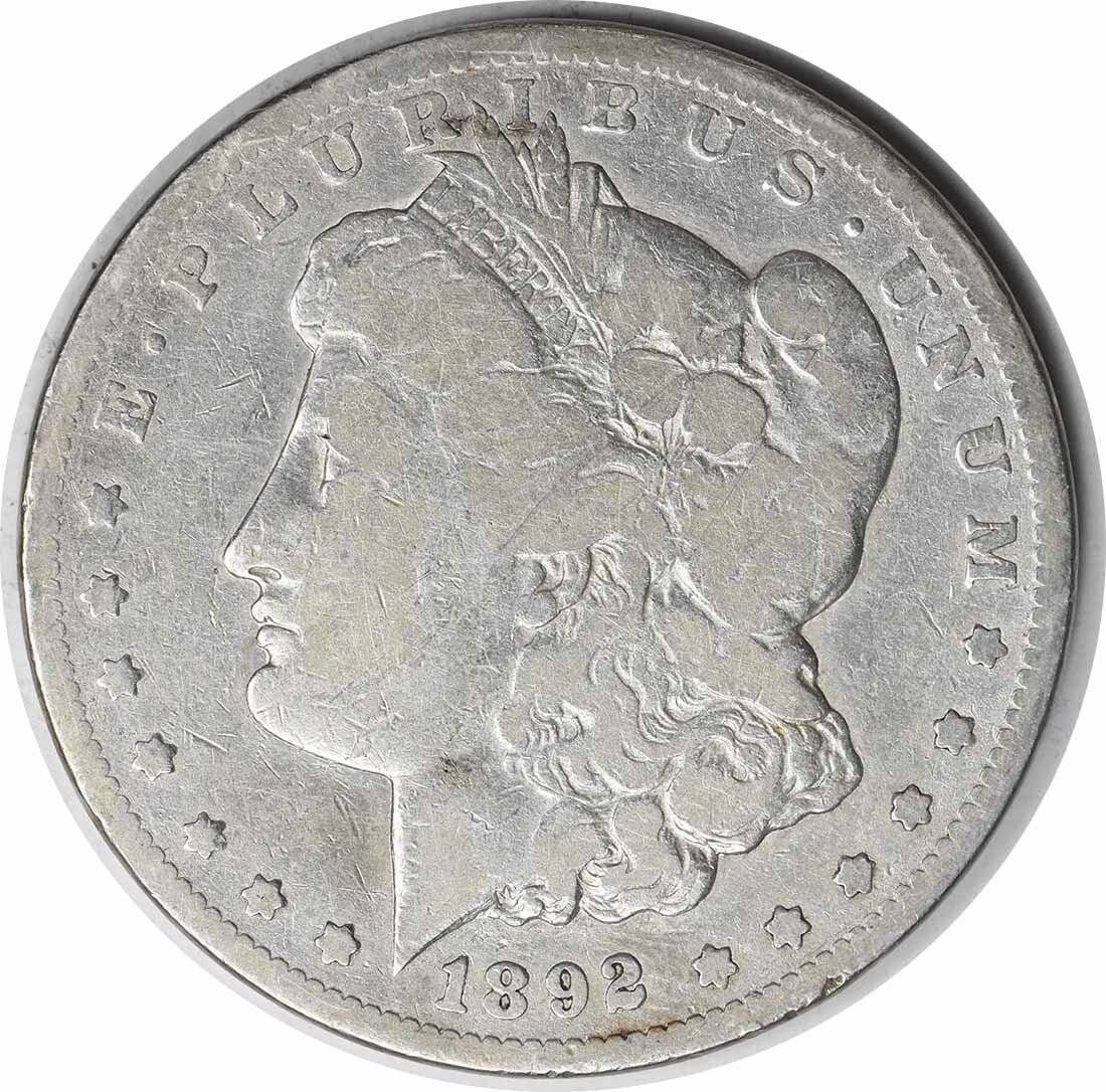 1892-CC Morgan Silver Dollar VG Uncertified Coin 90% Silver: 1892-CC Morgan Silver Dollar VG Uncertified Coin 90% Silver This 1892-CC Morgan Silver Dollar is a classic piece of American numismatic history. Struck at the Carson City Mint, this coin features the 