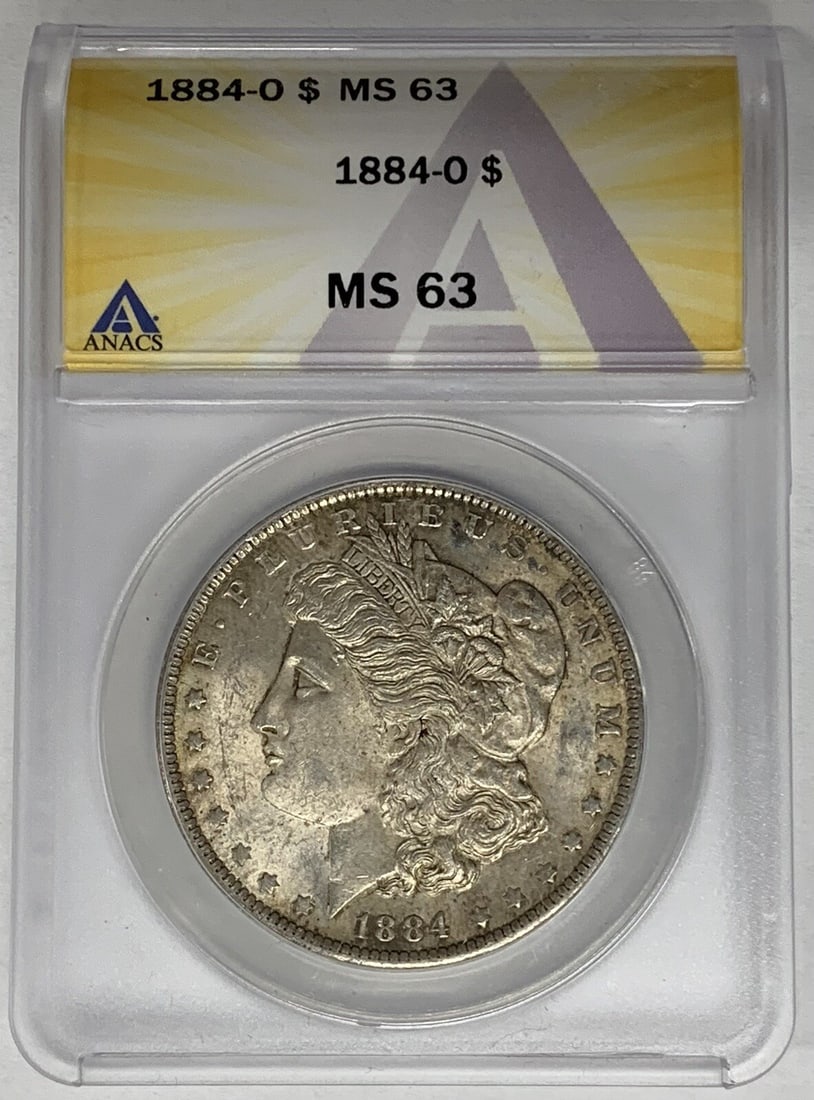 ANACS MS 63 1884-O Morgan Dollar Silver Coin with Light Toning: ANACS MS 63 1884-O Morgan Dollar Silver Coin with Light Toning This 1884-O Morgan Silver Dollar is an uncirculated coin with light toning, certified by ANACS with a grade of MS 63. It features the cla