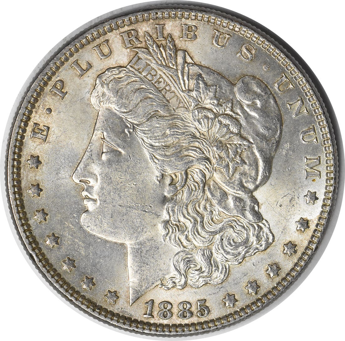Choice BU 1885 Silver Morgan Dollar With Toned Finish Uncertified: Choice BU 1885 Silver Morgan Dollar With Toned Finish Uncertified This 1885 Morgan Silver Dollar is a Choice Brilliant Uncirculated (BU) coin. It features attractive toning and has not been certified 