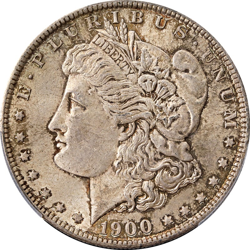 PCGS MS63 1900-O Morgan Silver Dollar with Attractive Toning: PCGS MS63 1900-O Morgan Silver Dollar with Attractive Toning This 1900-O Morgan Silver Dollar is graded MS63 by PCGS and features attractive toning. Struck at the New Orleans Mint, this uncirculated c