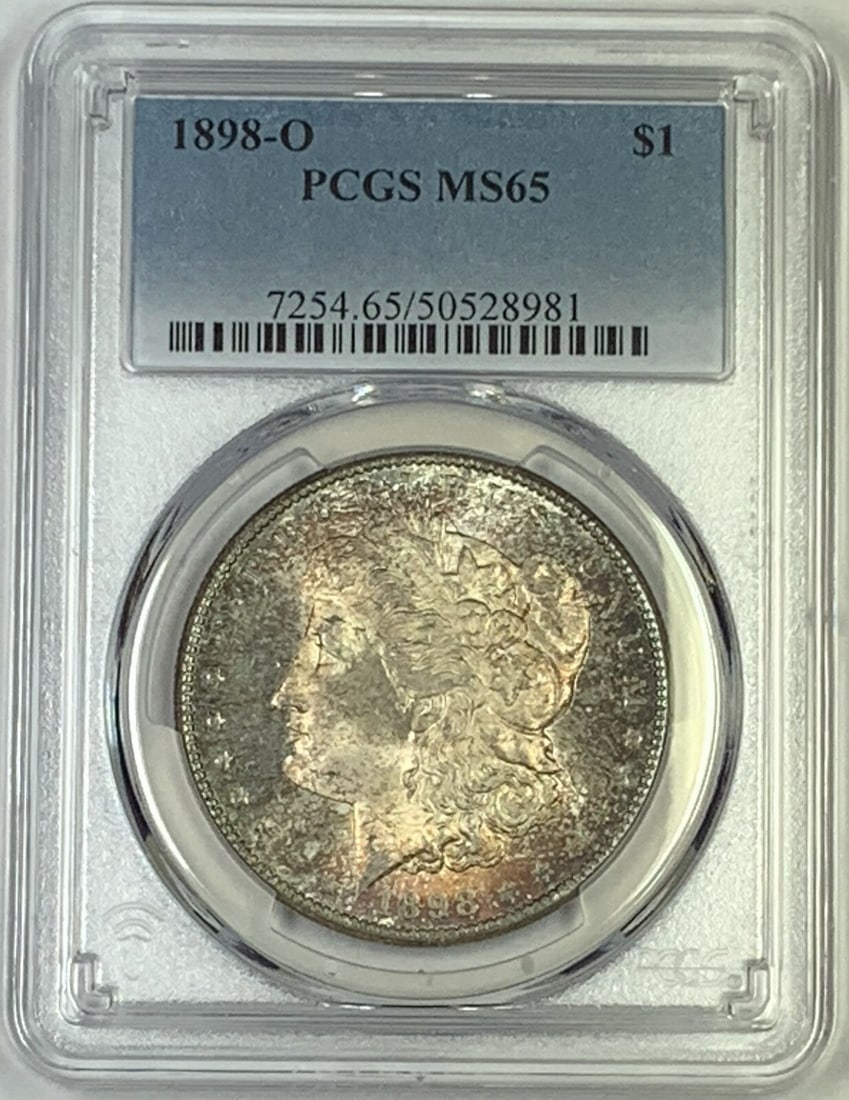 PCGS MS 65 1898-O Morgan Dollar with Attractive Toning: PCGS MS 65 1898-O Morgan Dollar with Attractive Toning This 1898-O Morgan Silver Dollar is graded MS 65 by PCGS and features attractive toning. The coin is uncirculated and composed of silver. It was 