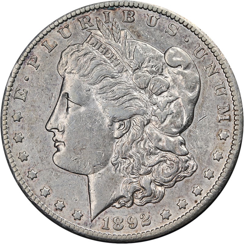 1892-CC Morgan Silver Dollar Choice XF Key Date Silver Coin: 1892-CC Morgan Silver Dollar Choice XF Key Date Silver Coin This 1892-CC Morgan Silver Dollar is a key date coin known for its striking eye appeal and nice strike. It features a beautiful silver compo