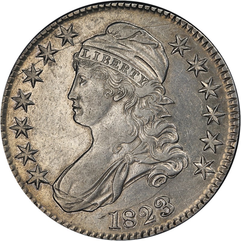 1823 Bust Half Dollar Reworked '3' AU Silver Coin: 1823 Bust Half Dollar Reworked '3' AU Silver Coin This 1823 Bust Half Dollar is a remarkable piece, showcasing nice eye appeal with lustrous surfaces and a strong strike. It is graded as AU, reflectin