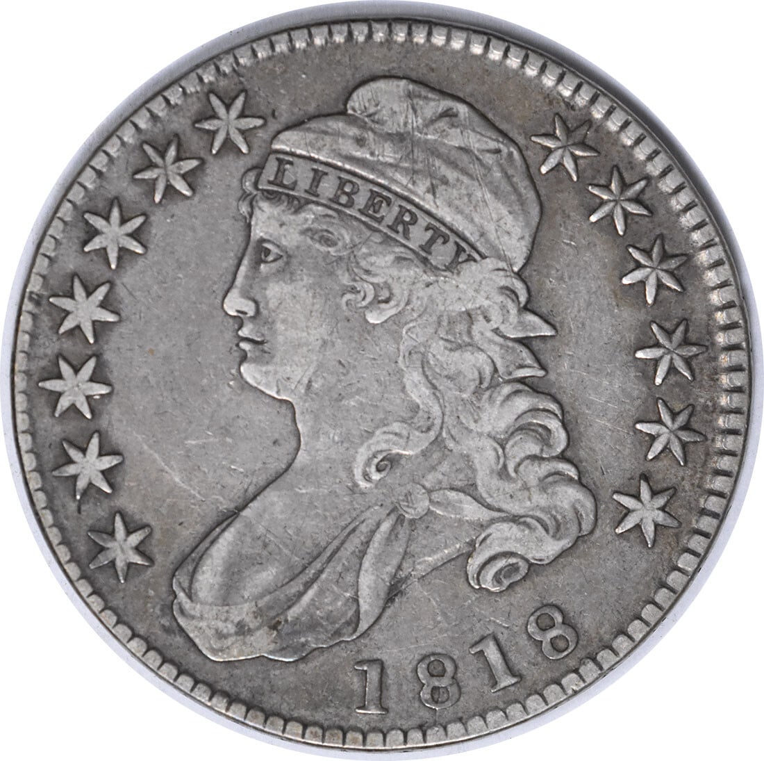1818 Bust Silver Half Dollar O-104A VF by John Reich: 1818 Bust Silver Half Dollar O-104A VF by John Reich This 1818 Bust Silver Half Dollar, designated as O-104A and R-3, is an exquisite piece of numismatic history. Struck in Philadelphia, it features a