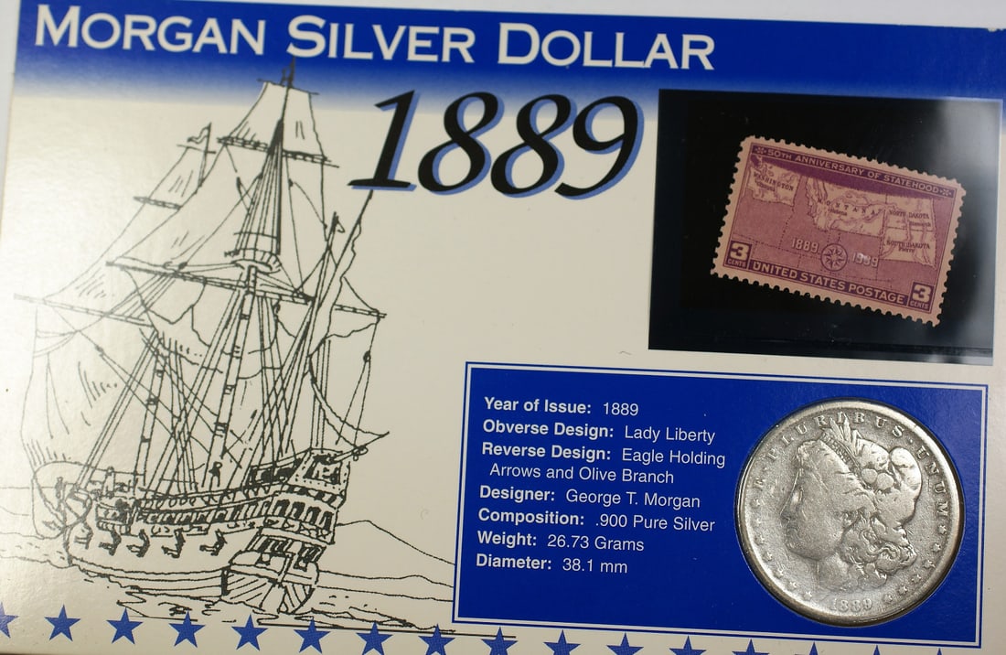 1889-O Morgan Silver Dollar With 3c Statehood Stamp Plus Fact Sheet: 1889-O Morgan Silver Dollar With 3c Statehood Stamp Plus Fact Sheet This set includes an 1889-O Morgan Silver Dollar coin from the New Orleans Mint, accompanied by a 3 Cent Statehood stamp and a fact 