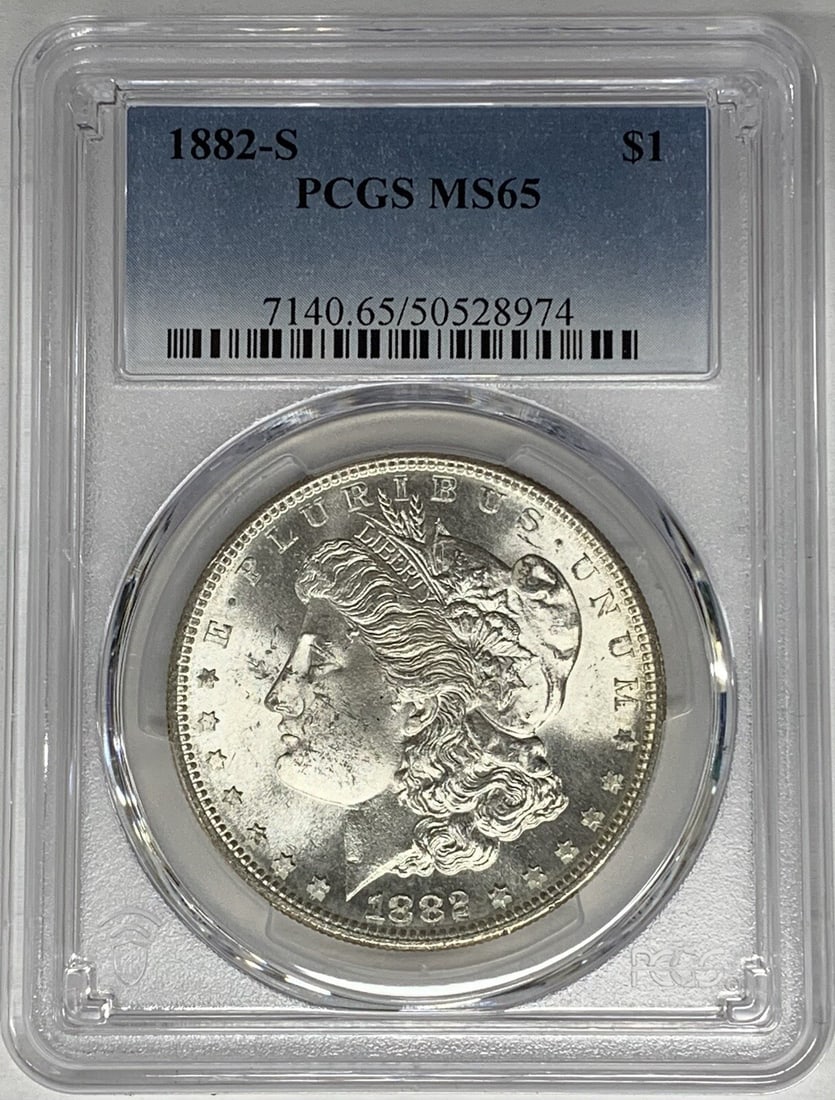 PCGS MS 65 1882-S Morgan Silver Dollar $1 Coin United States: PCGS MS 65 1882-S Morgan Silver Dollar $1 Coin United States This 1882-S Morgan Silver Dollar is certified by PCGS with a grade of MS 65. The coin is uncirculated and composed of silver, offering a hi