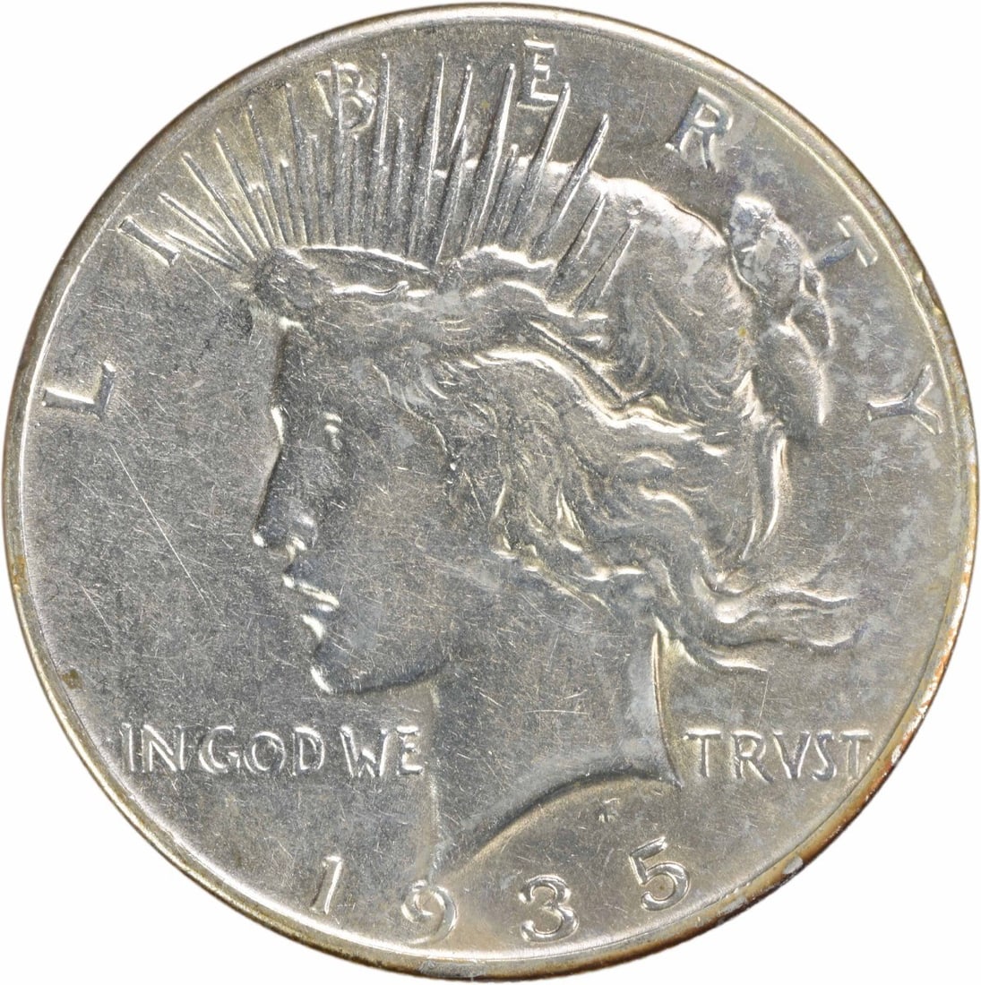 1935 Peace Silver Dollar EF Uncertified 90% Silver Coin: 1935 Peace Silver Dollar EF Uncertified 90% Silver Coin This 1935 Peace Silver Dollar is a remarkable piece of American numismatic history, featuring the iconic design by Anthony de Francisci. The coi