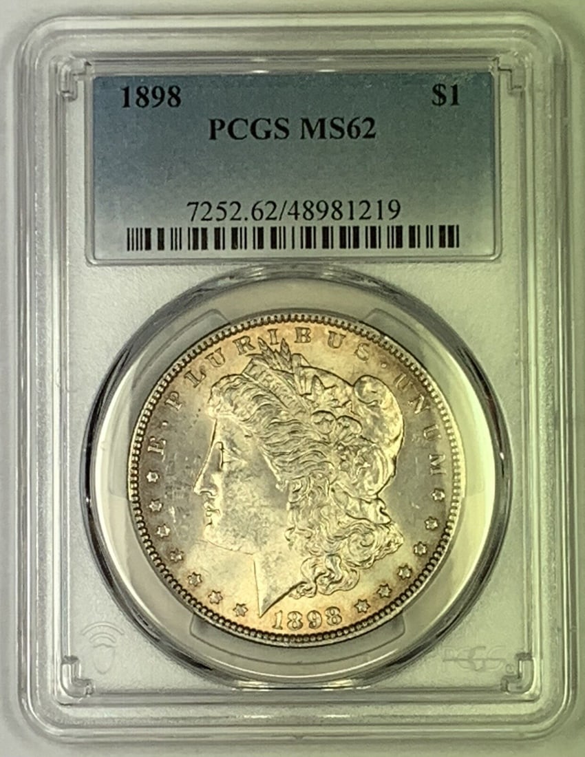 1898 Morgan Silver Dollar PCGS MS 62 Certified Lightly Toned Coin: 1898 Morgan Silver Dollar PCGS MS 62 Certified Lightly Toned Coin This is an 1898 Morgan Silver Dollar from the United States. The coin is lightly toned and has been graded MS 62 by PCGS. It is compos
