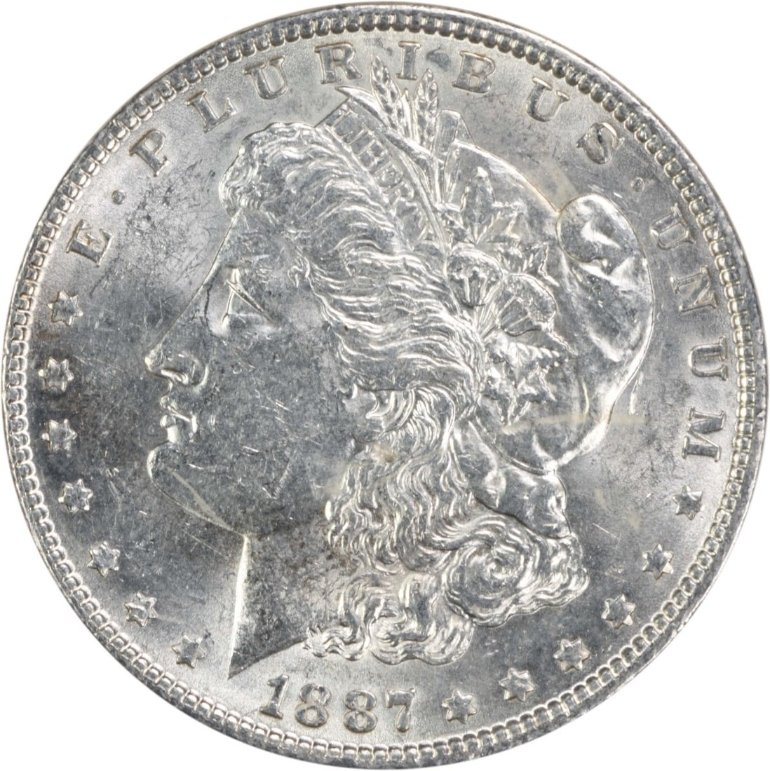 1887 Morgan Silver Dollar AU Uncertified 90% Silver Coin: 1887 Morgan Silver Dollar AU Uncertified 90% Silver Coin This 1887 Morgan Silver Dollar is an iconic piece of American numismatics, showcasing the artistry of designer George T. Morgan. It is classifi